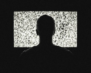 Man looking at tv screen in dark