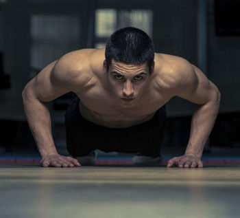 Shirtless man doing pushups