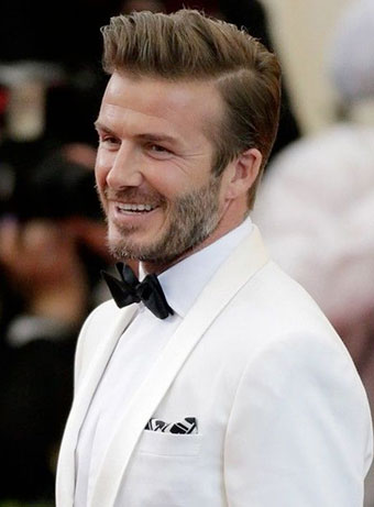 David Beckham in a white tuxedo with tapered hair