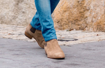 man wearing jeans and chelsea boots