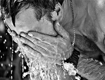 Man washing his face in black and white