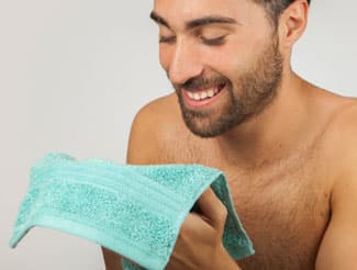 Man washing face with cloth