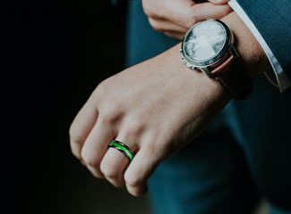Man wearing green unique wedding ring