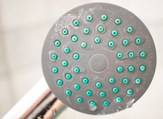 A shower head with hard water residue