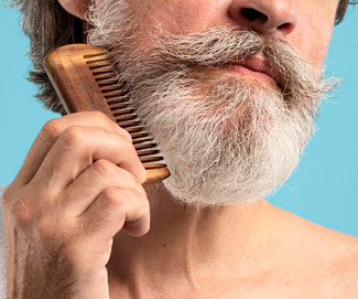 Man combing grey beard