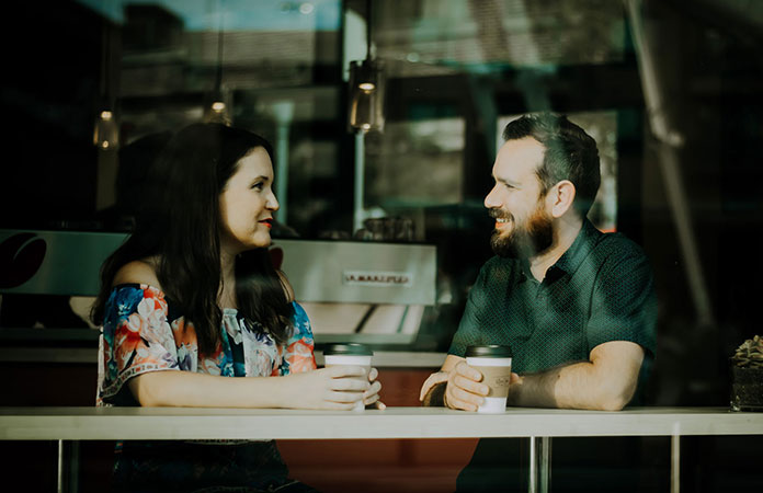 New couple having conversation in coffee shop 