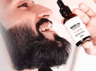 Bearded man holding bottle of beard oil 