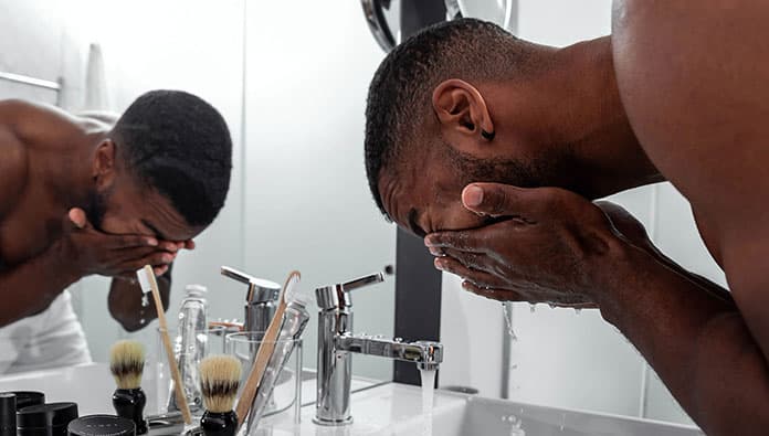 Bearded man washing his face