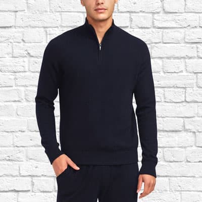 man wearing black half zip sweater