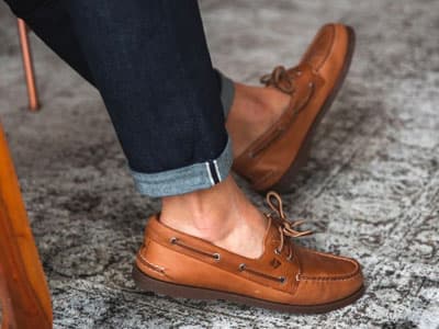 man wearing jeans and boat shoes