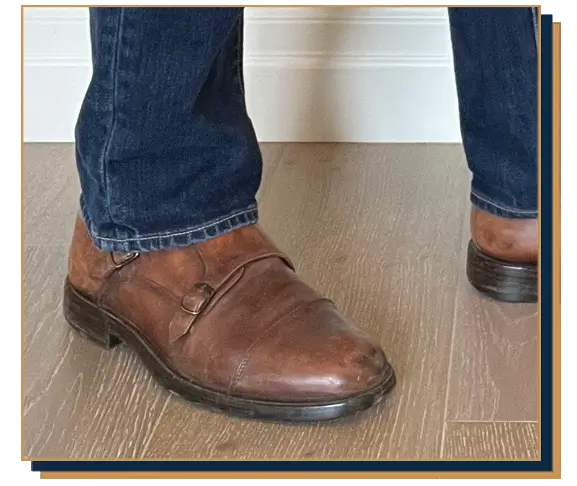 Dave Bowden wearing blue jeans and brown leather double monk strap shoes
