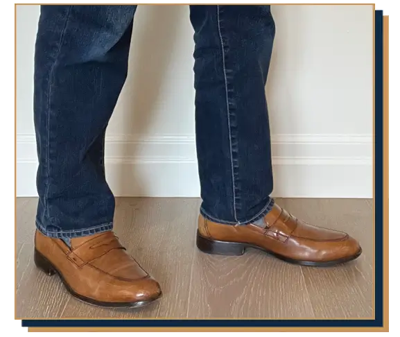 Dave Bowden wearing blue jeans and brown leather penny loafers