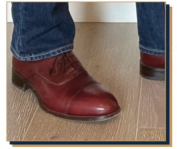 Dave Bowden wearing blue jeans and burgundy leather oxford shoes