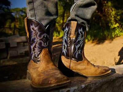 man wearing jeans and cowboy boots