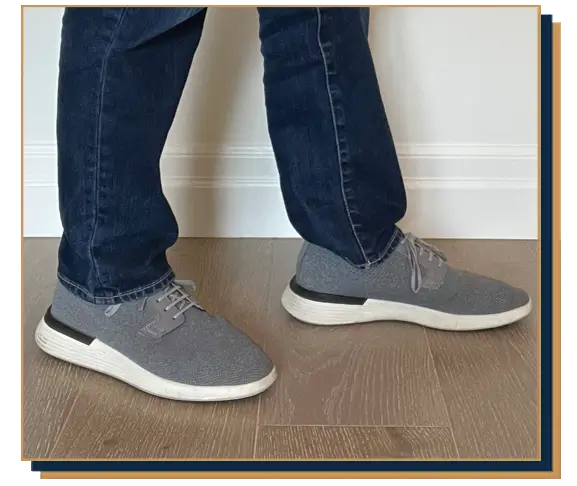 Dave Bowden wearing blue jeans and grey hybrid sneakers from Wolf and Shepherd