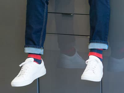 man wearing jeans and white sneakers