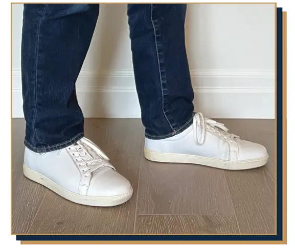 Dave Bowden wearing blue jeans and white leather sneakers from Allen Edmonds
