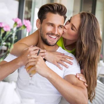 Woman kissing handsome man