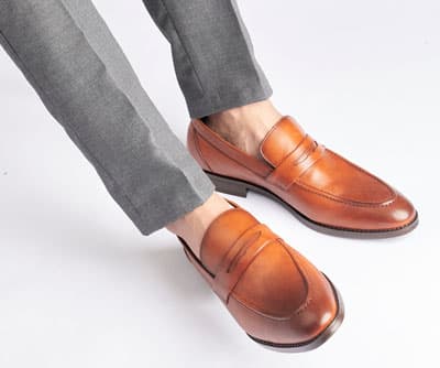 Man wearing penny loafers with no socks