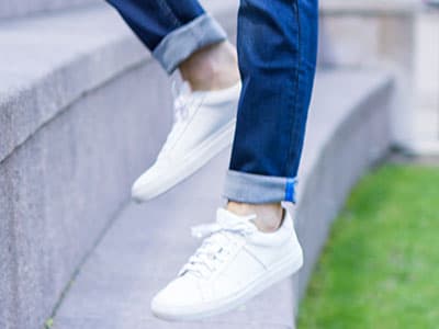Man wearing white sneakers with no socks