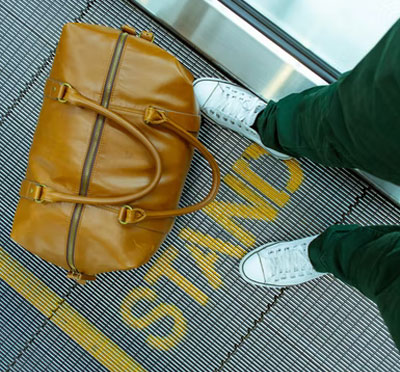 Leather travel bag on escalator