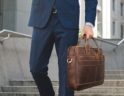 Man carrying brown leather work bag