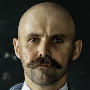 Bald man with short beardstache
