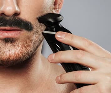 Man trimming his beardstache