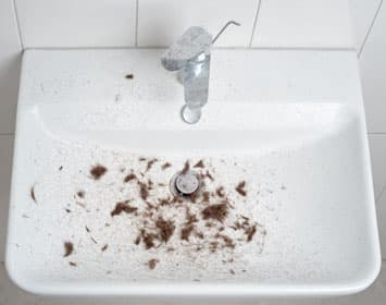 Cut beard hair in bathroom sink