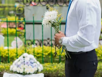 Man at a funeral without a suit