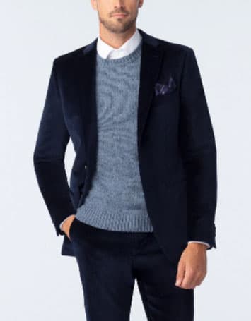 Man wearing a thick sweater under a suit jacket