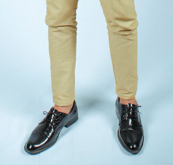 man wearing black shoes and khaki pants