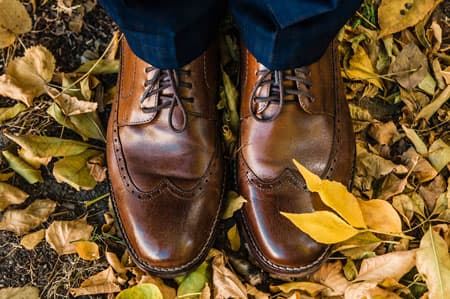 Brogue shoes stepping in leaves