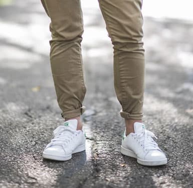 man wearing white shoes and khakis