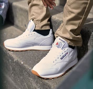 man wearing white shoes and khakis