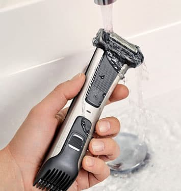Rinsing the Norelco Body Groomer under a tap