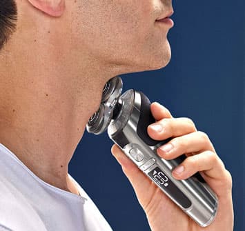 Man shaving his neck with rotary shaver