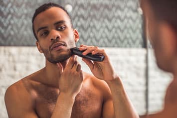 Handsome Black man shaving
