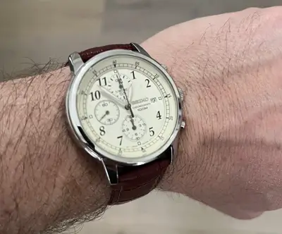 Close up of Dave Bowden wearing a Seiko chronograph with cream watch dial and leather strap