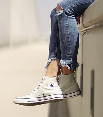 Person wearing off-white Converse high tops