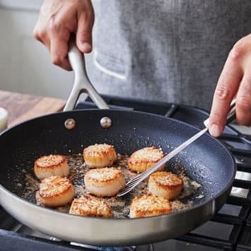 Person cooking scallops 