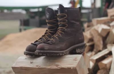 Logger boots sitting on lumber