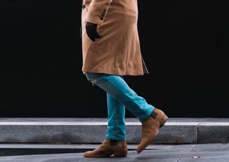 Man wearing blue jeans and chelsea boots