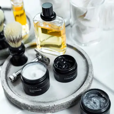 Aftershave, razor and face creams on bathroom counter