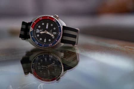 A Nato strap watch with a Pepsi dial