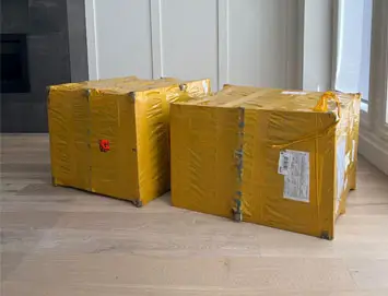 Two boxes containing Eames chair replica