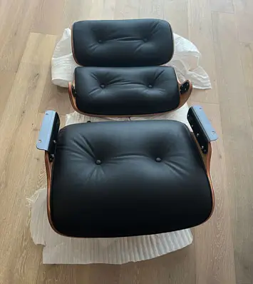 Separate pieces of Sohnne Eames replica laying on the floor