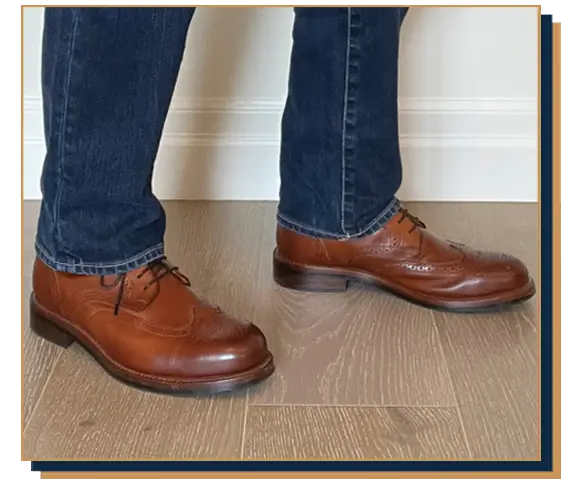 Dave Bowden wearing blue jeans and brown leather brogue boots from Beckett Simonon