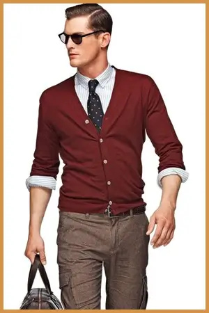 Man wearing a burgundy cardigan over a shirt and tie