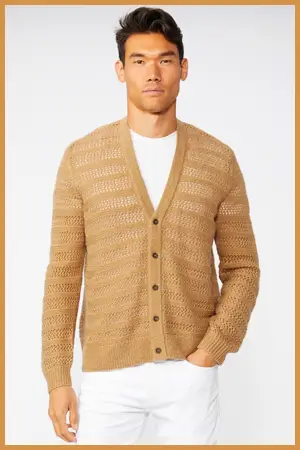 Man wearing a beige cardigan over a white tee